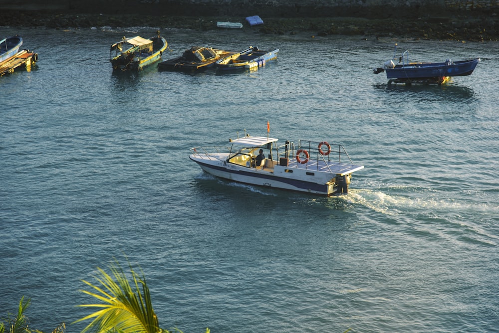 a group of boats floating on top of a body of water