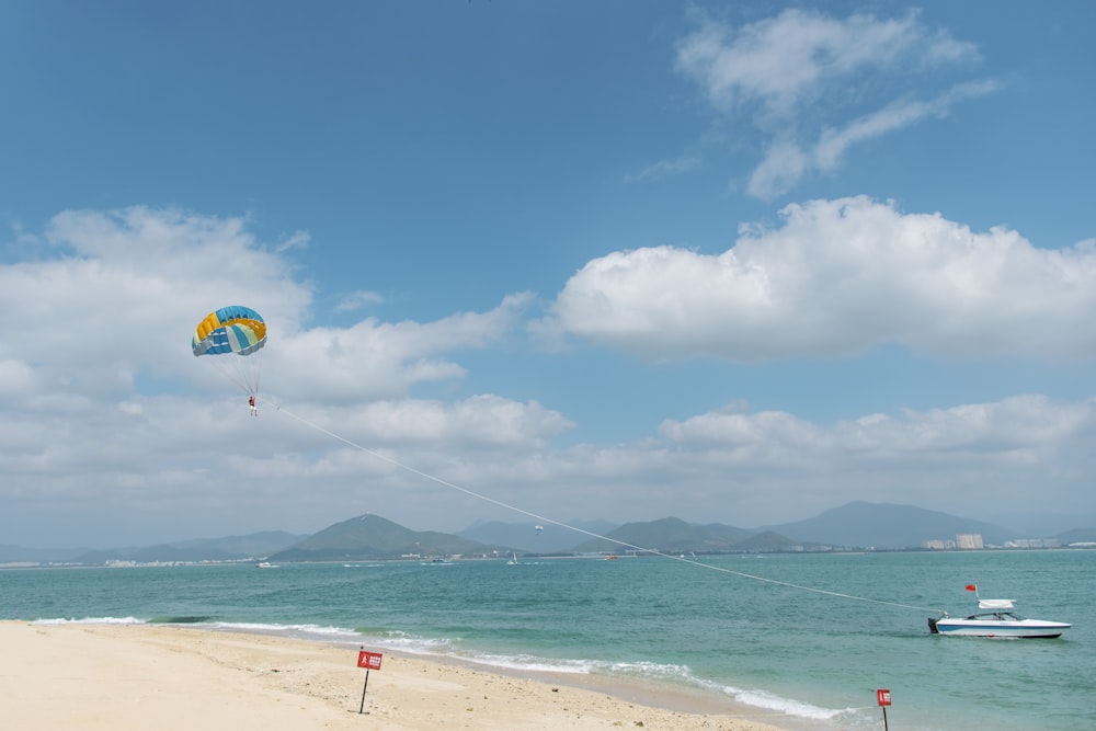 a person flying a kite on the beach