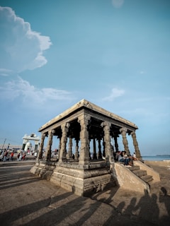 a group of people sitting on top of a stone structure