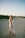 a woman standing in the sand on a beach