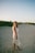 a woman standing in the sand on a beach