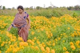 a woman in a field of yellow flowers