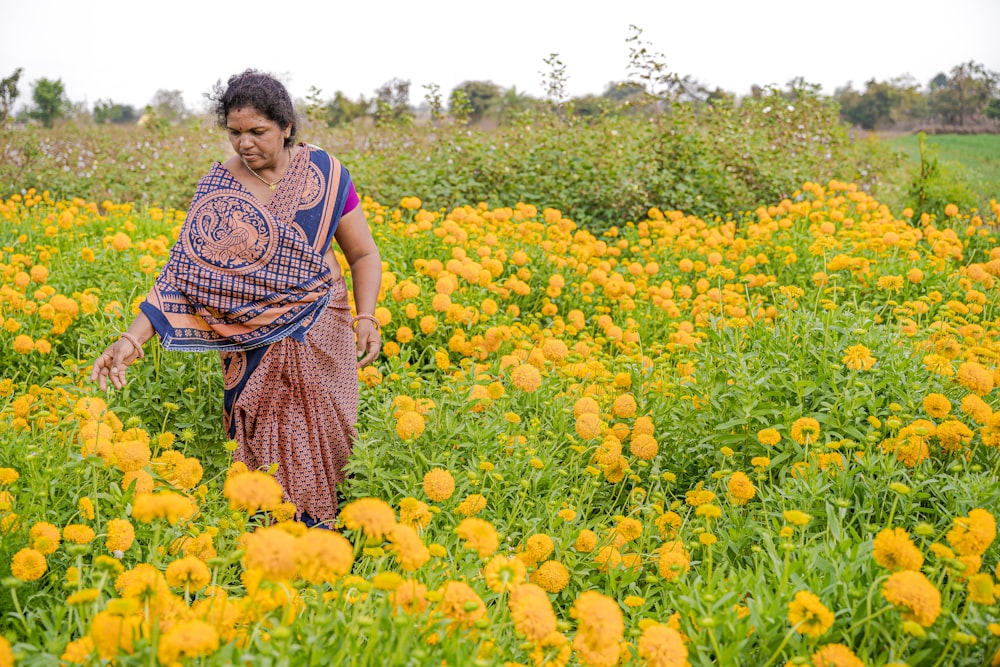 a woman in a field of yellow flowers