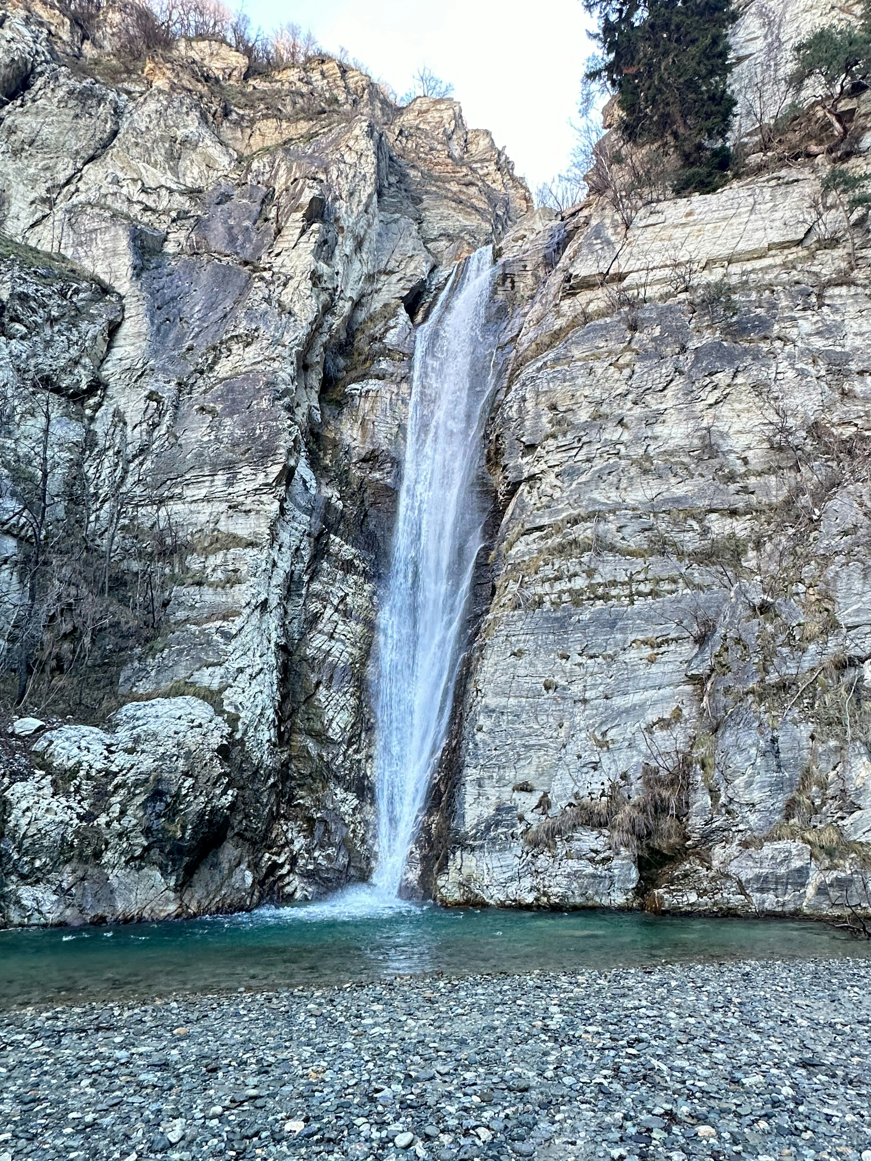 a large waterfall is coming down the side of a mountain