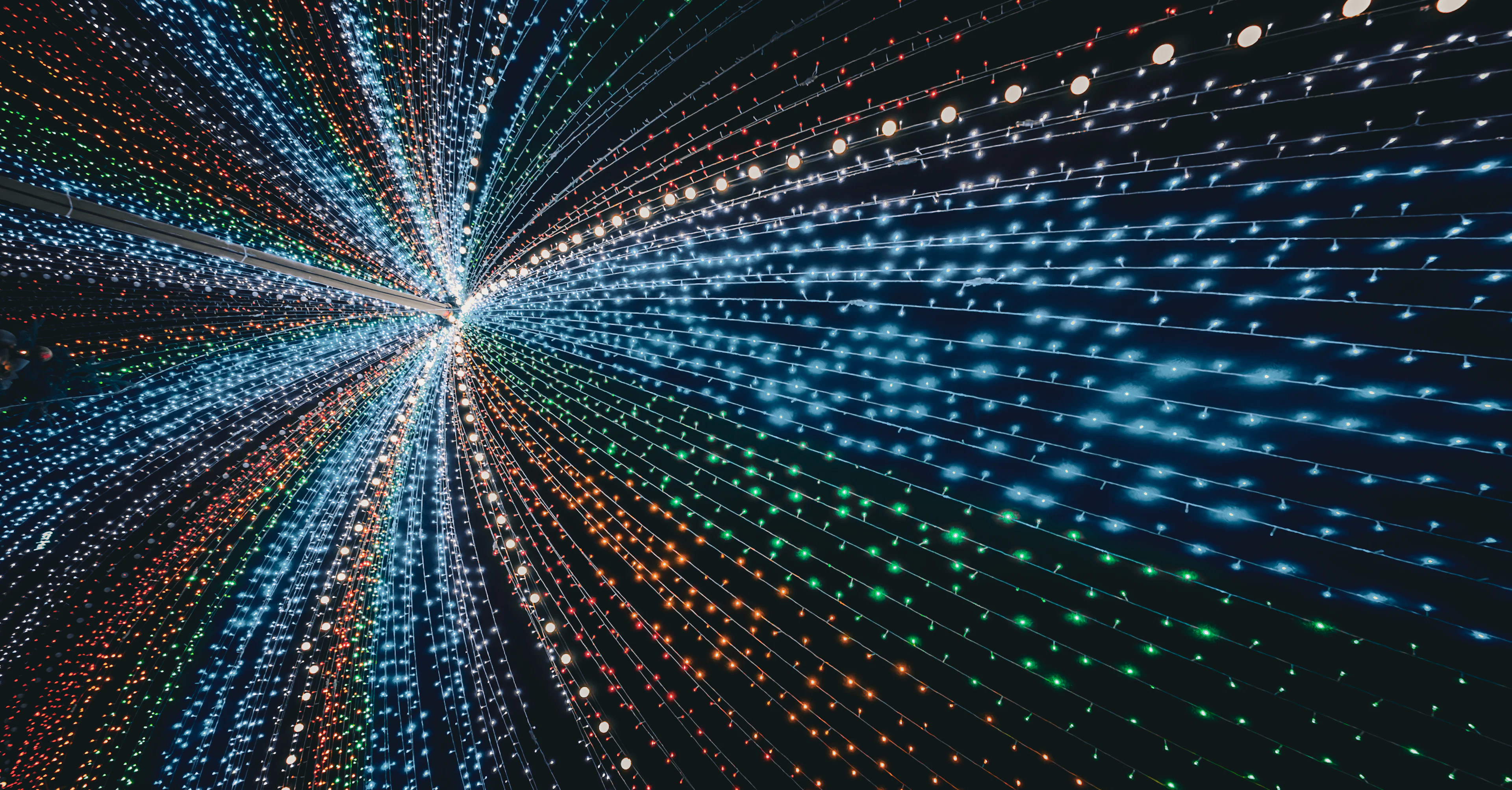 Streaks of coloured lights forming a tunnel in the dark