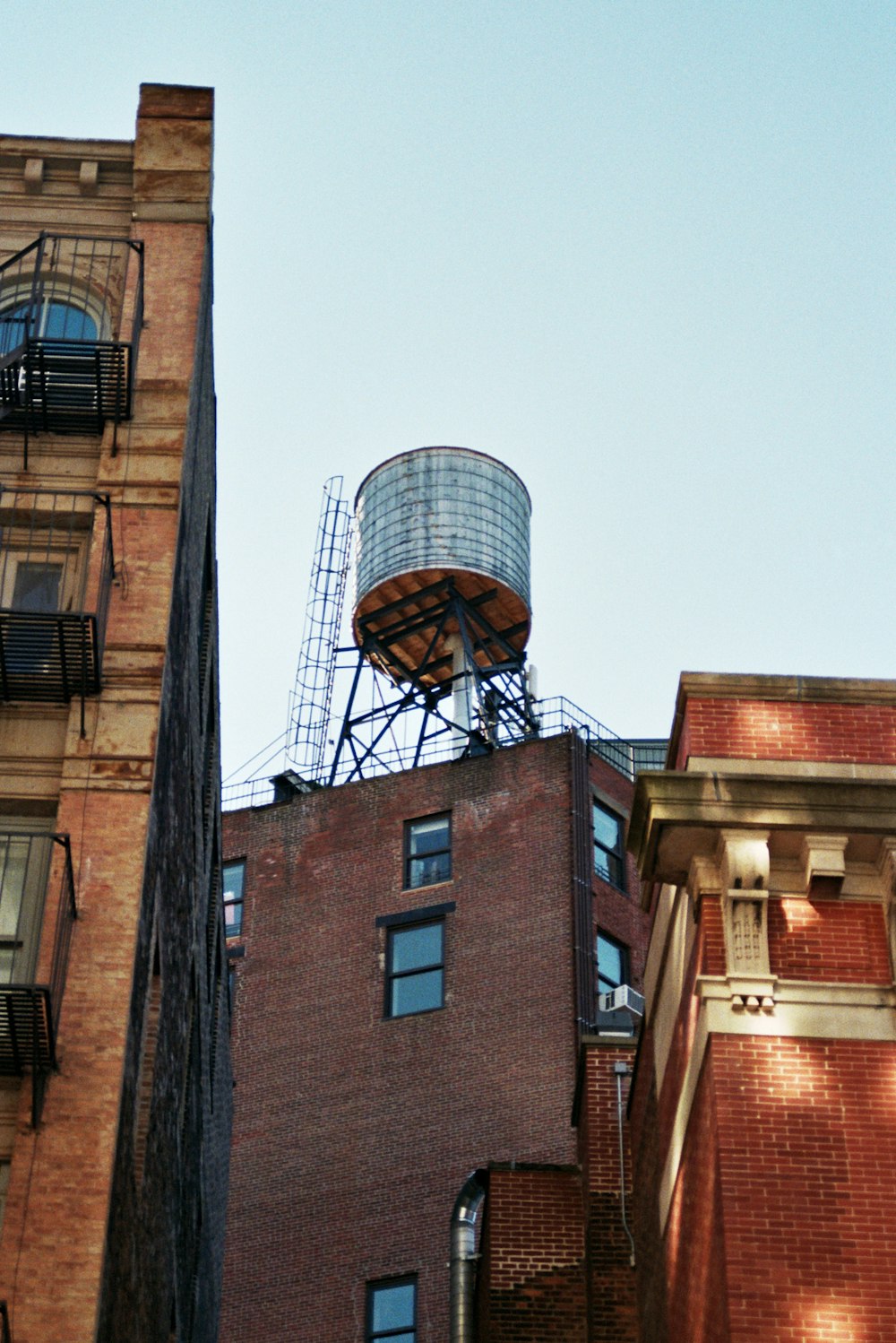 a tall brick building with a water tower on top