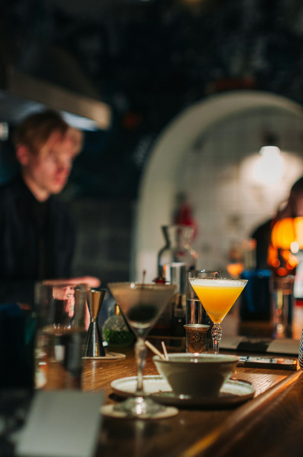 a man sitting at a bar with a bowl of food