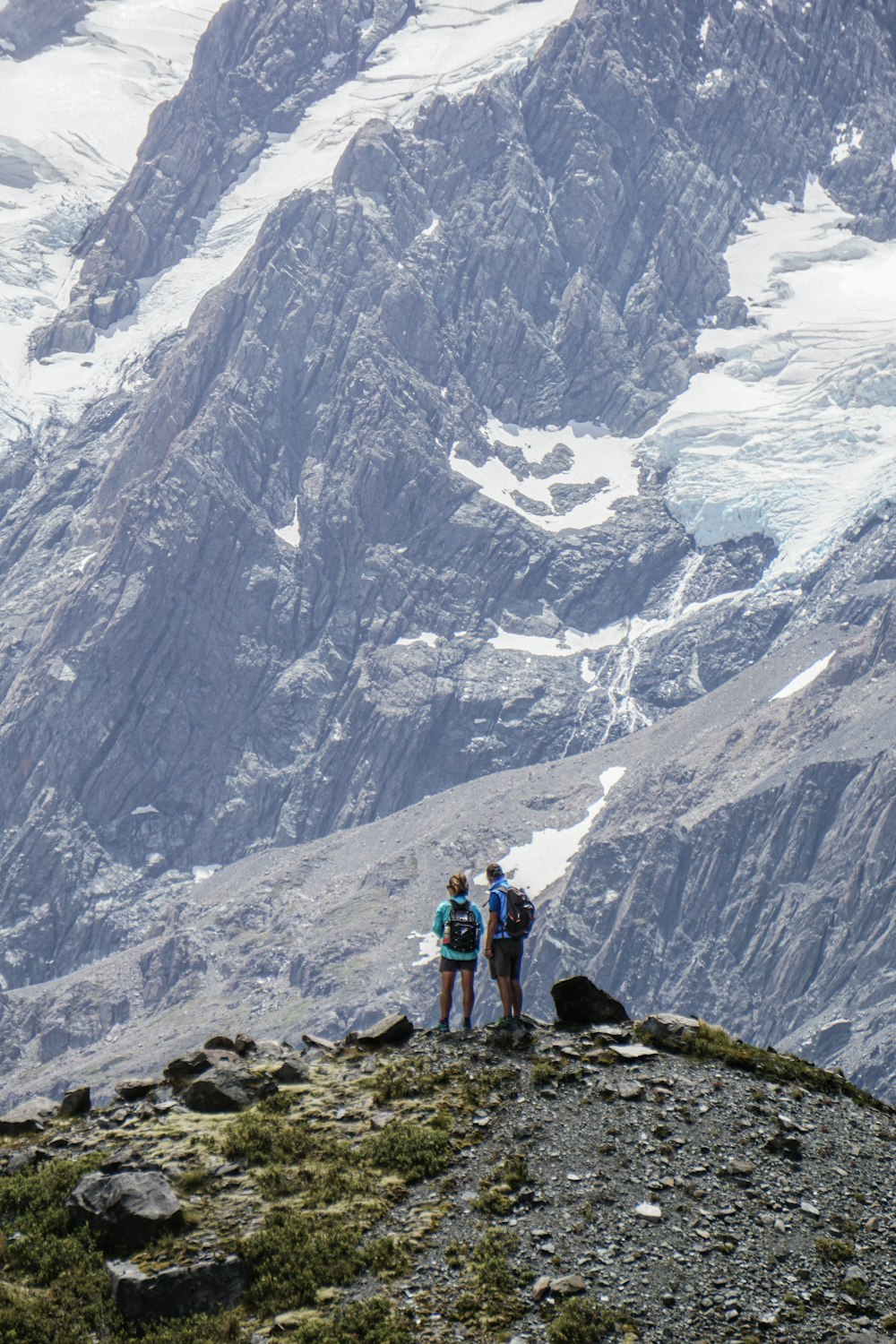 a group of people standing on top of a mountain