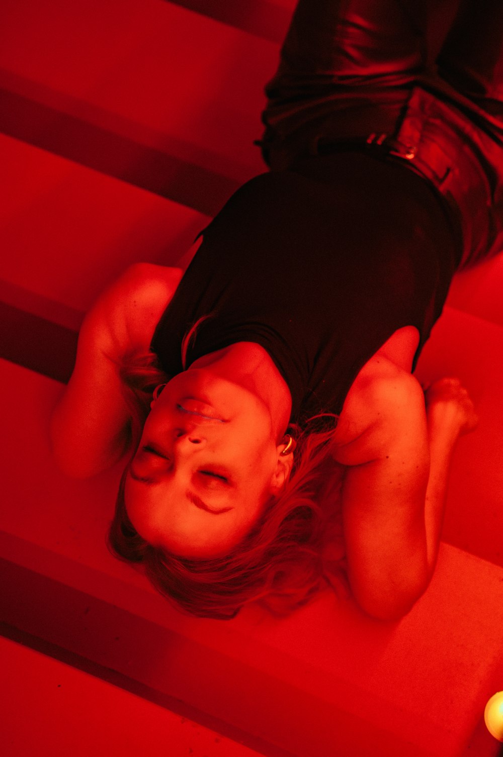 a woman laying on the floor in a red room