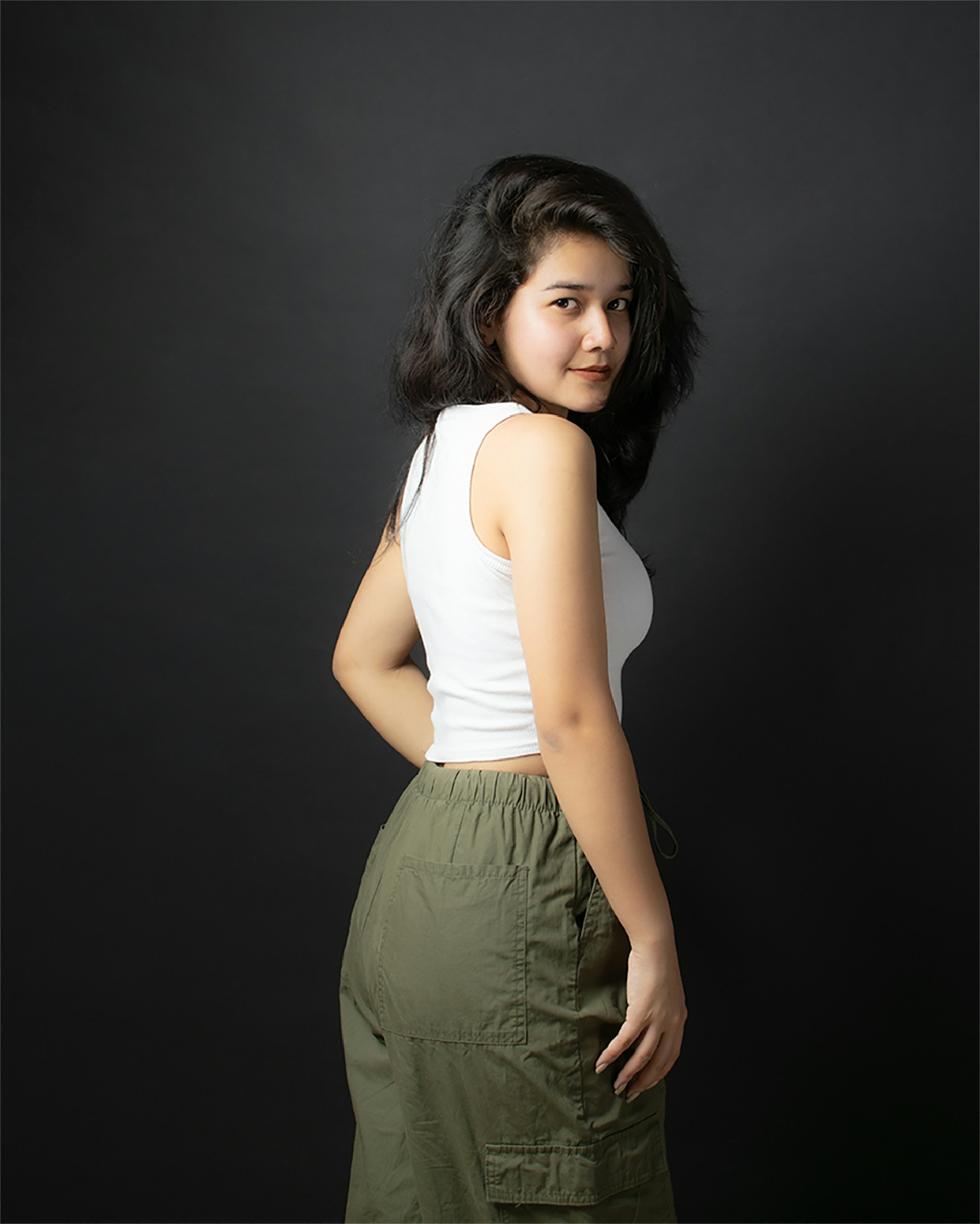 a woman standing in front of a black background