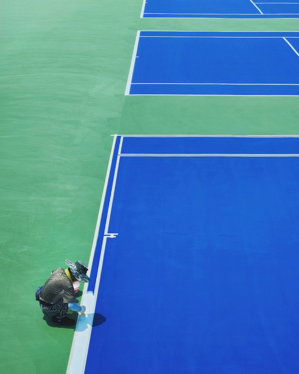 a person kneeling down on a tennis court