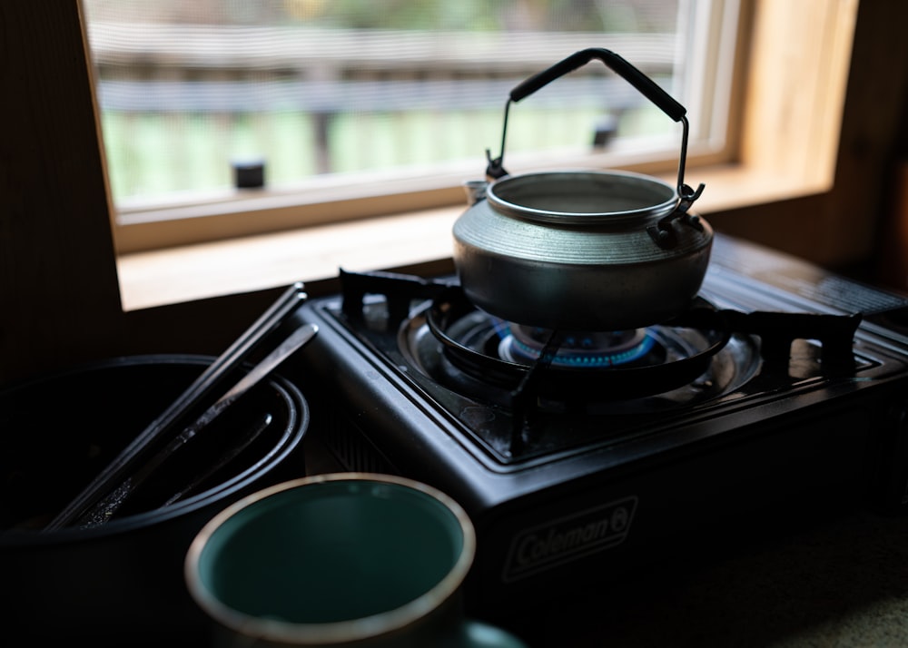 a tea kettle sitting on top of a stove