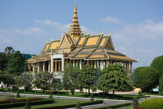 a large building with a golden roof surrounded by trees