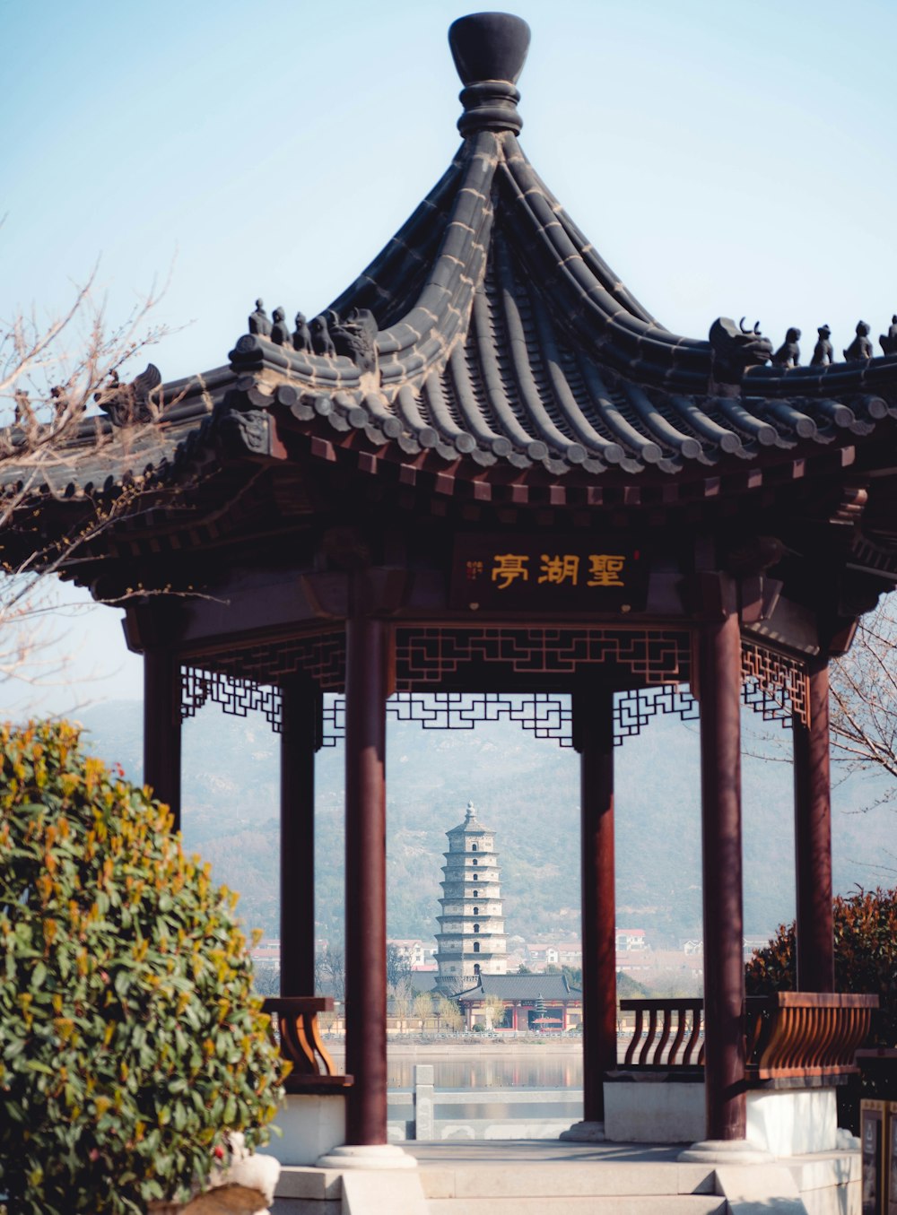 a gazebo with a pagoda in the background