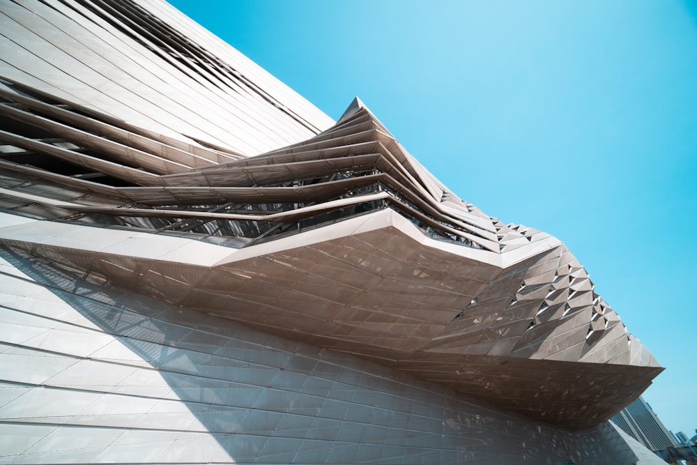 a building with a curved roof and a sky background