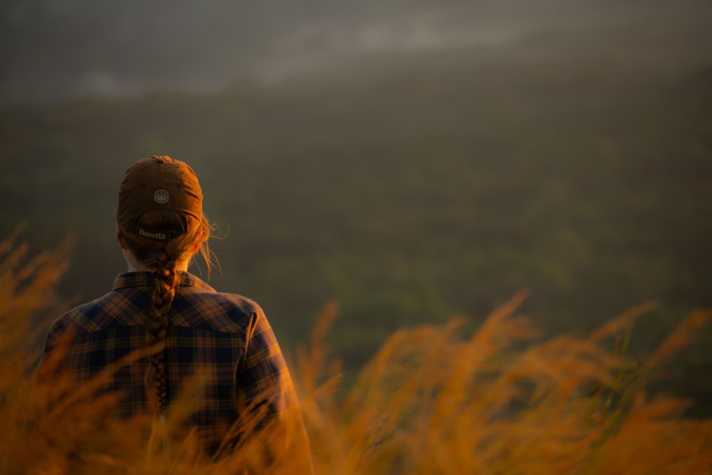 a person standing in a field of tall grass