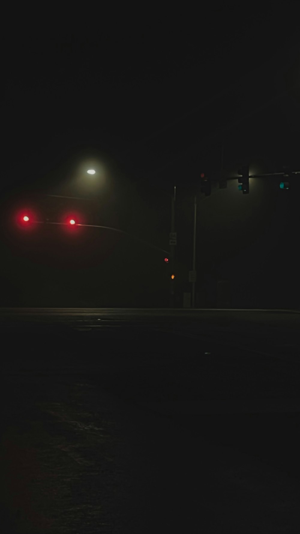 a stop light at night on a dark street