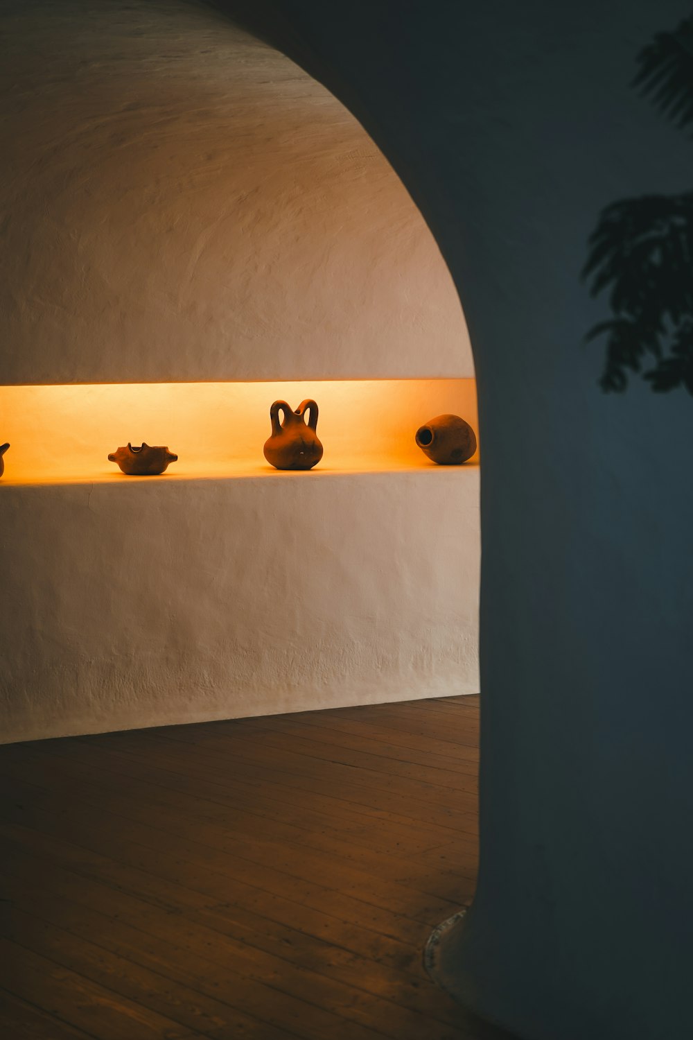 a group of vases sitting on top of a shelf