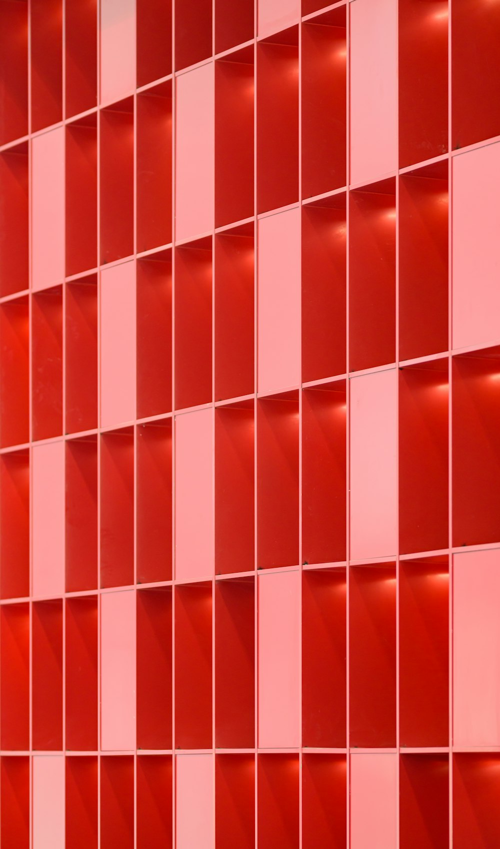 a close up of a red tiled wall