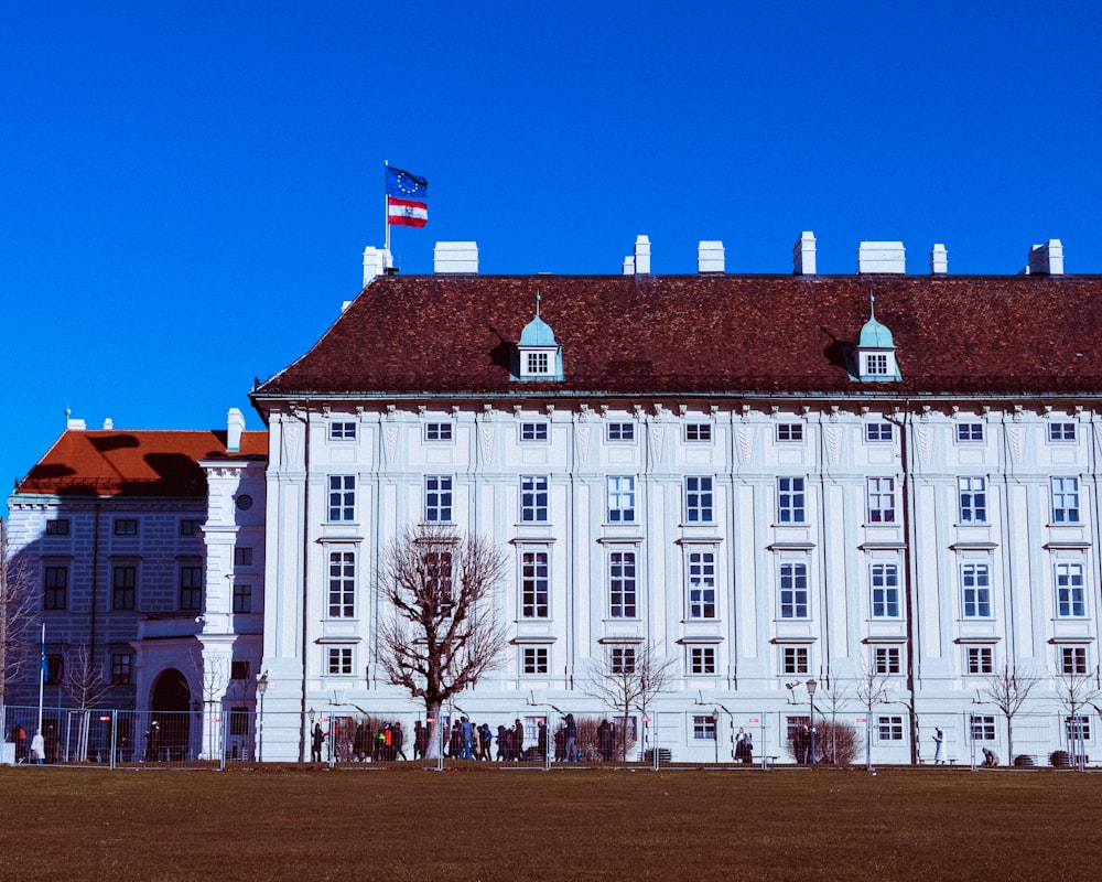 a large white building with a flag on top of it