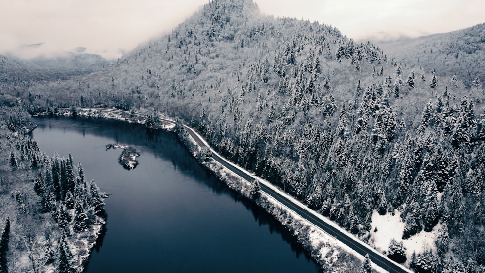 a large body of water surrounded by snow covered mountains