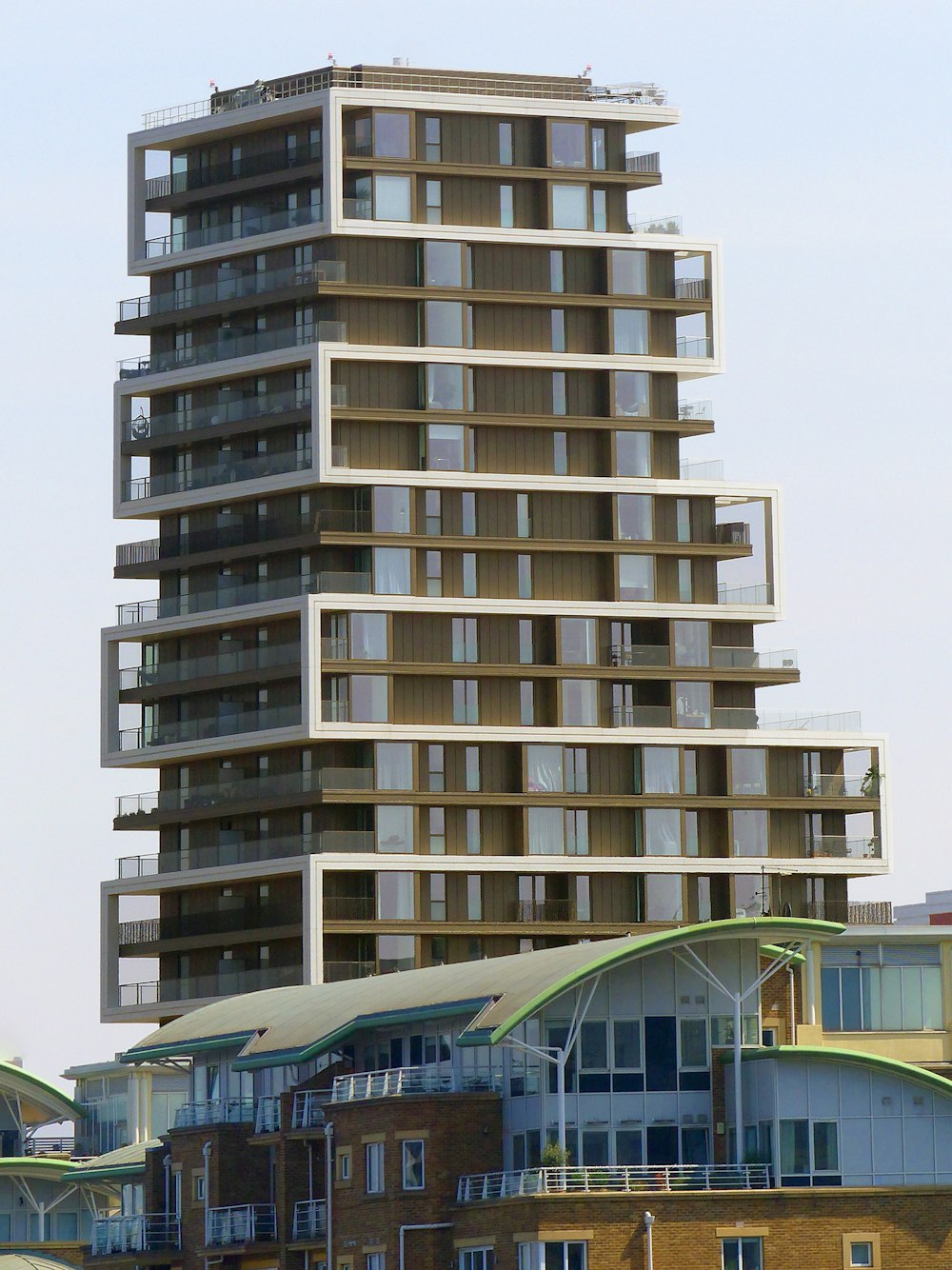 a tall building with balconies on top of it