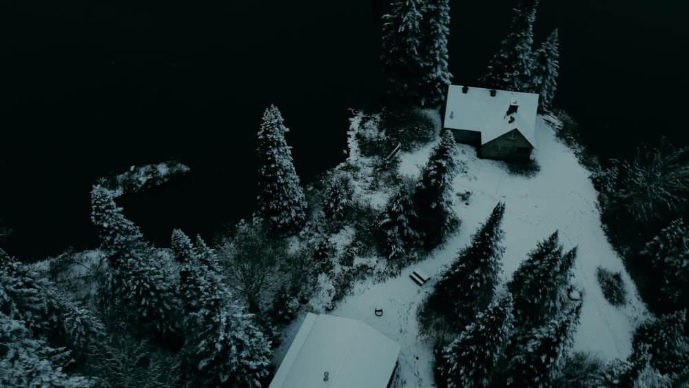 an aerial view of a house surrounded by trees