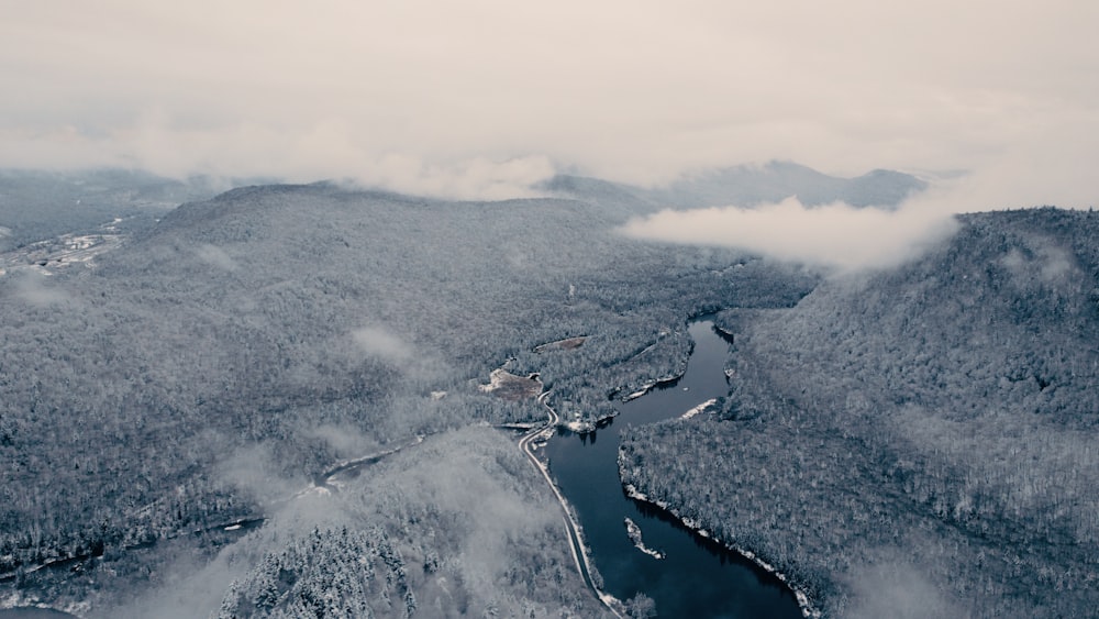 an aerial view of a river surrounded by mountains