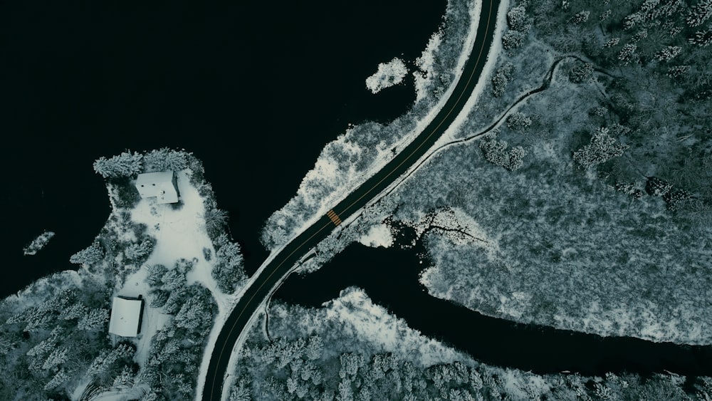 an aerial view of a road near a body of water