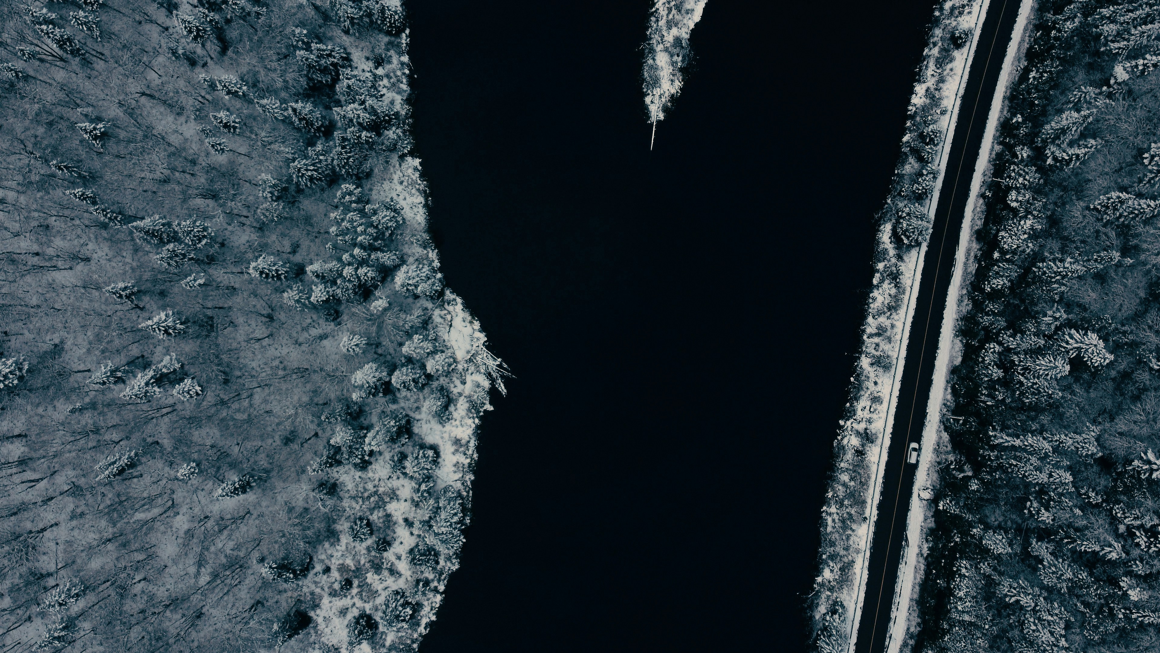 an aerial view of a body of water surrounded by trees