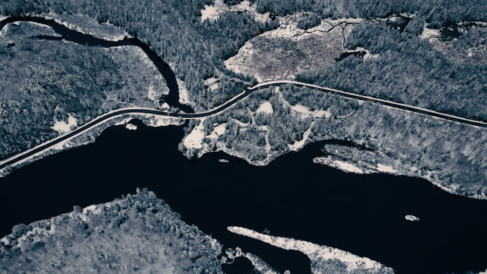 an aerial view of a winding road in the woods