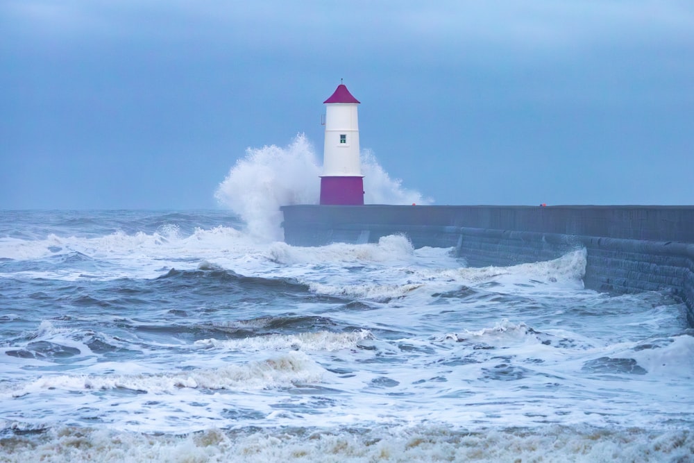 a lighthouse is surrounded by waves in the ocean