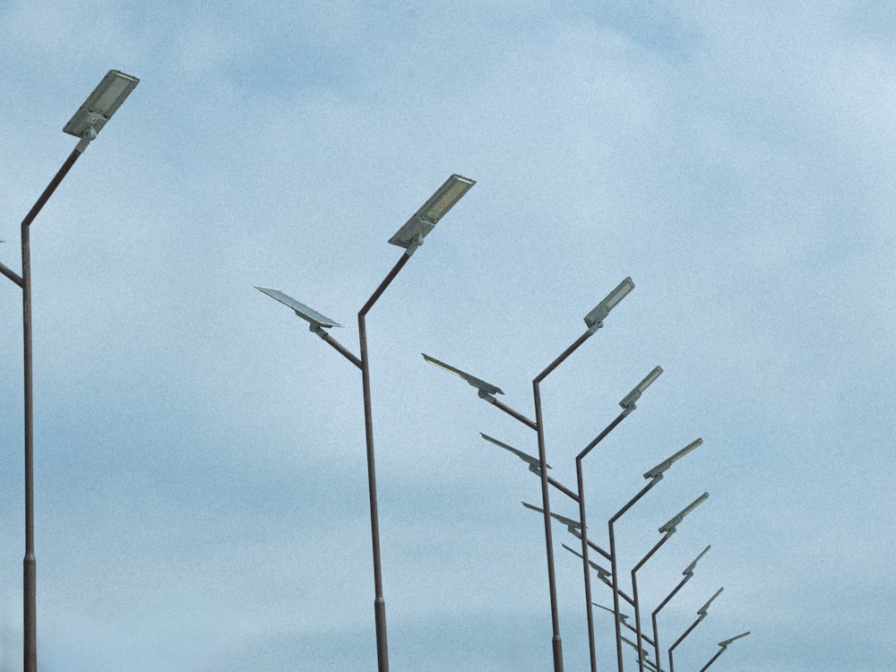 a row of street lights on a cloudy day