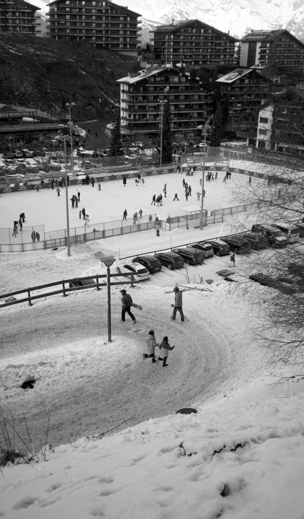 a black and white photo of people playing in the snow