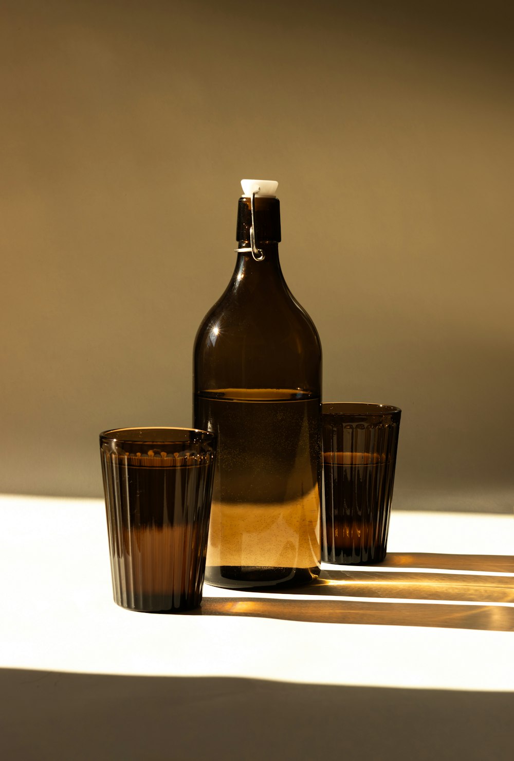 a bottle and two glasses sitting on a table