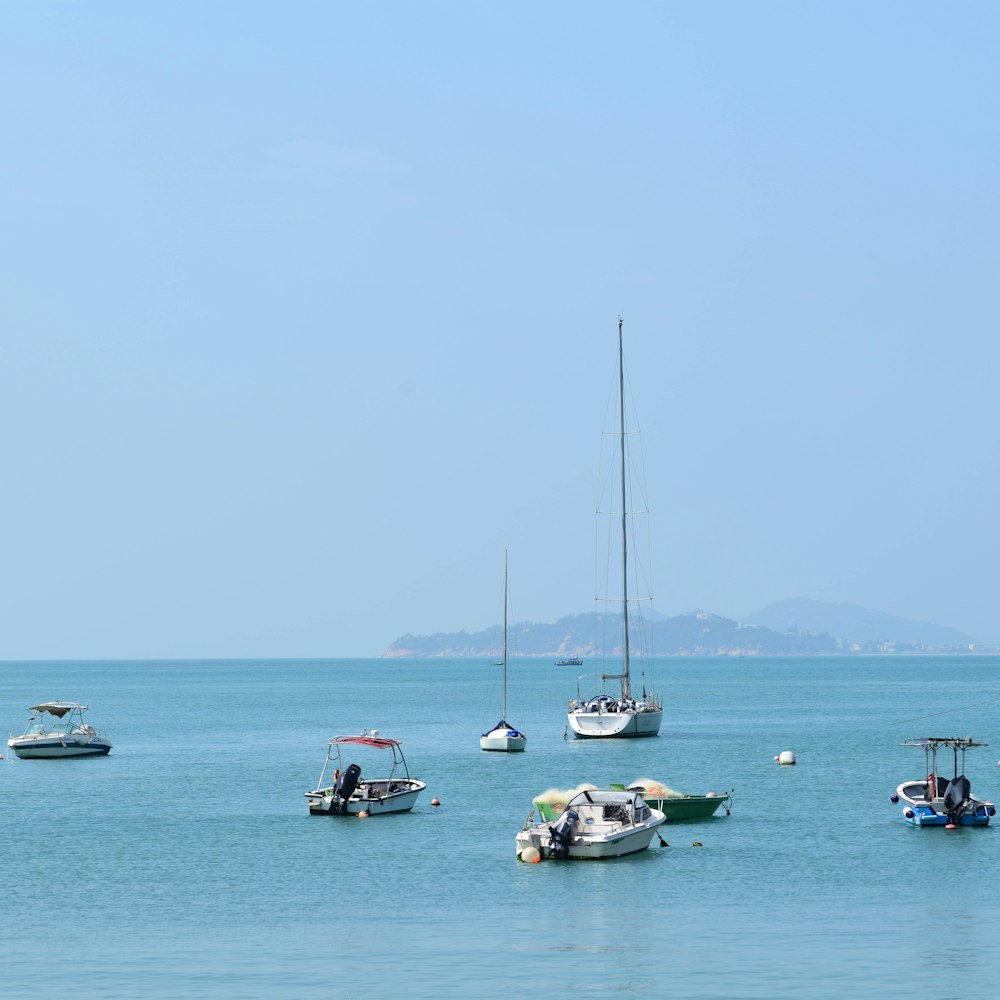 a group of boats floating on top of a large body of water