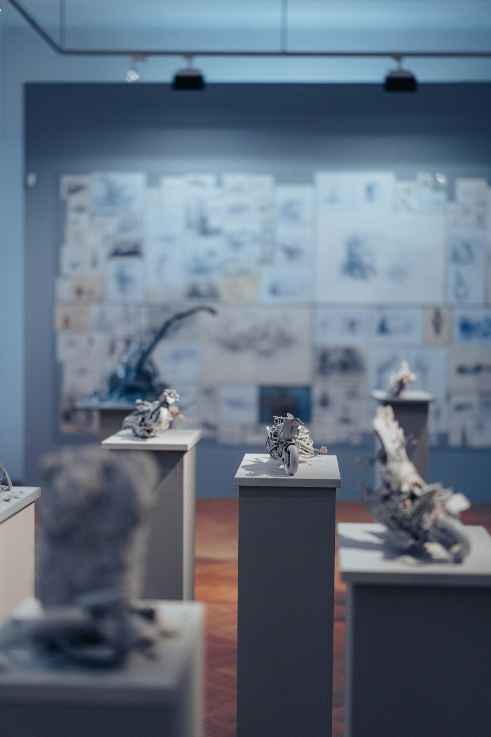 a group of sculptures sitting on top of white pedestals