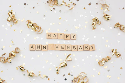 a happy anniversary spelled with scrabbles on a white background