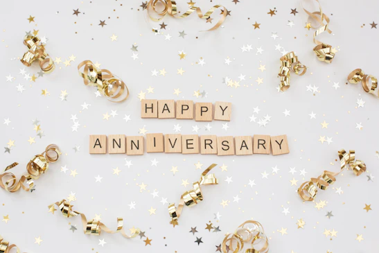 a happy anniversary spelled with scrabbles on a white background