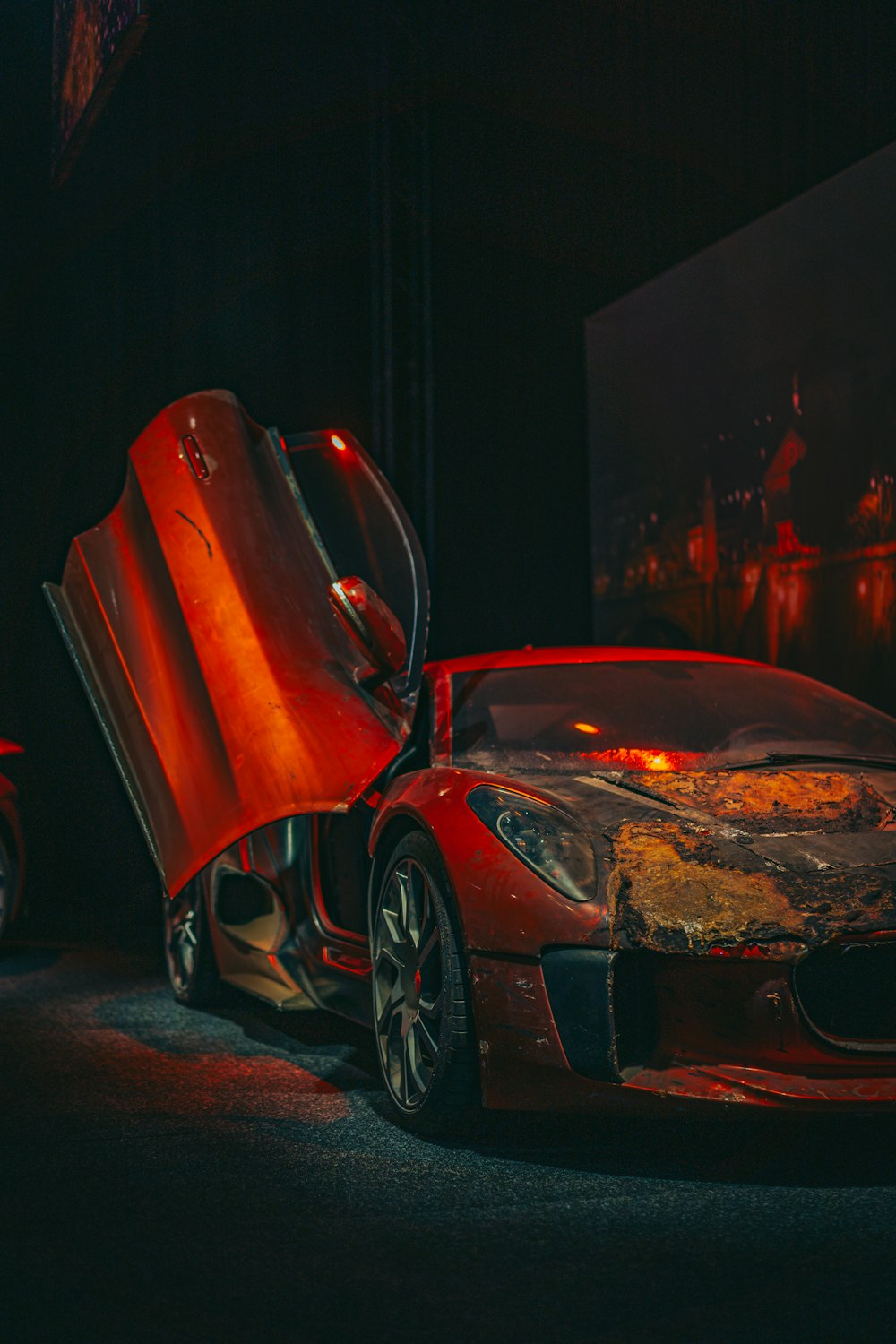 a red sports car with its hood open