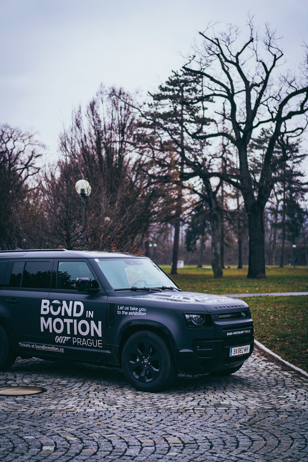 a black van parked on a cobblestone road