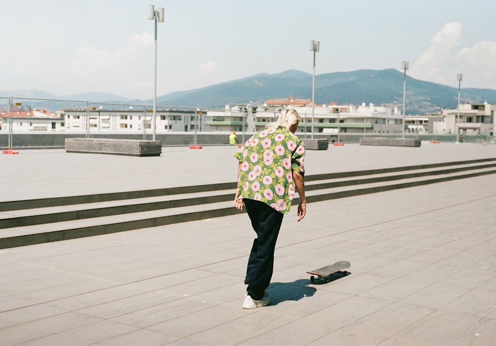 a man riding a skateboard down a cement walkway