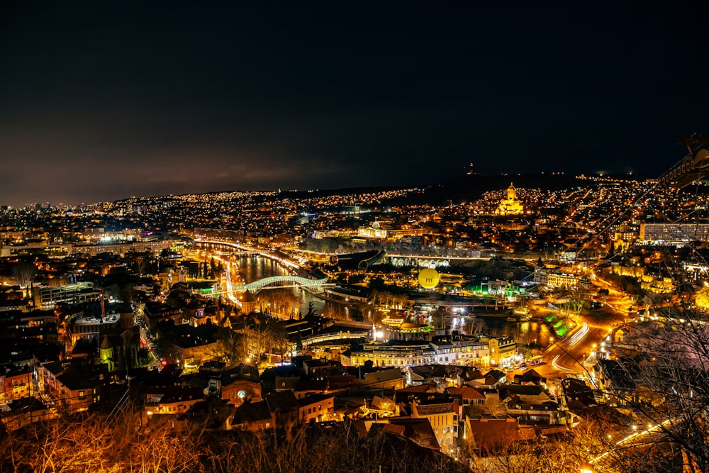 a view of a city at night from a hill