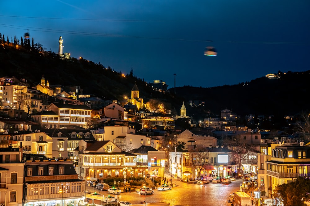 a view of a city at night from the top of a hill