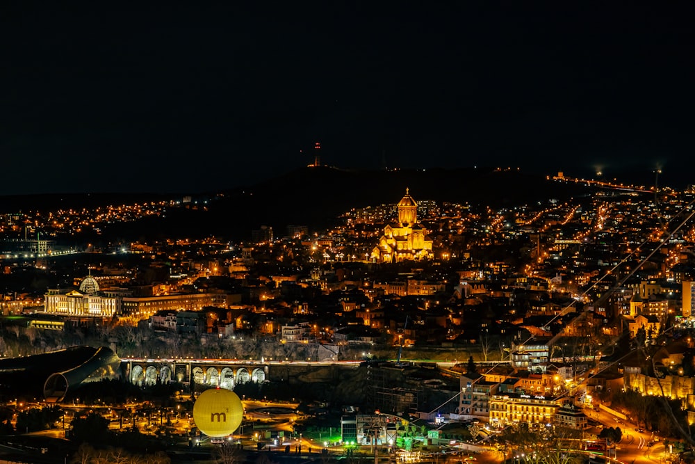 a view of a city at night from a hill