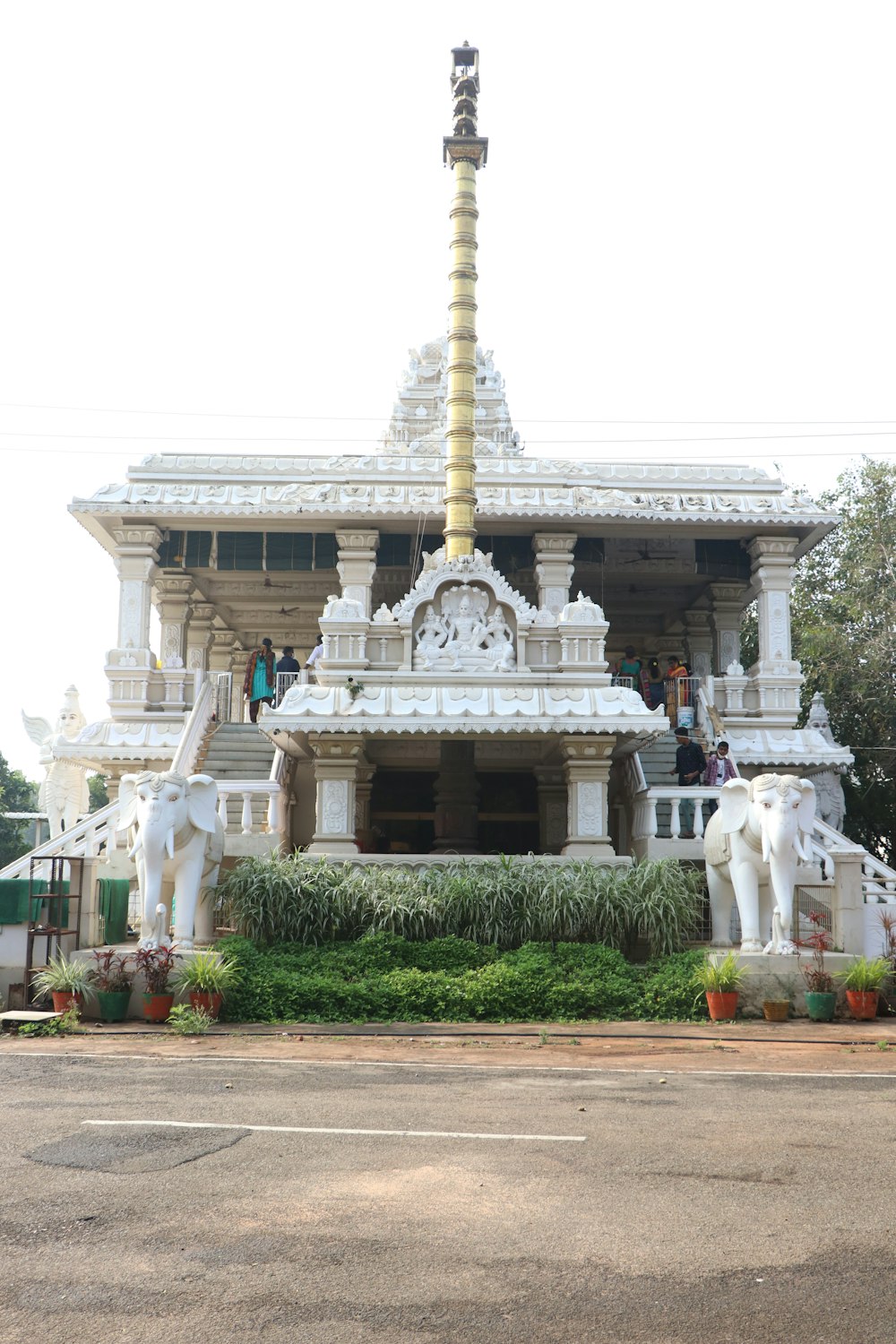 a large white building with statues of elephants