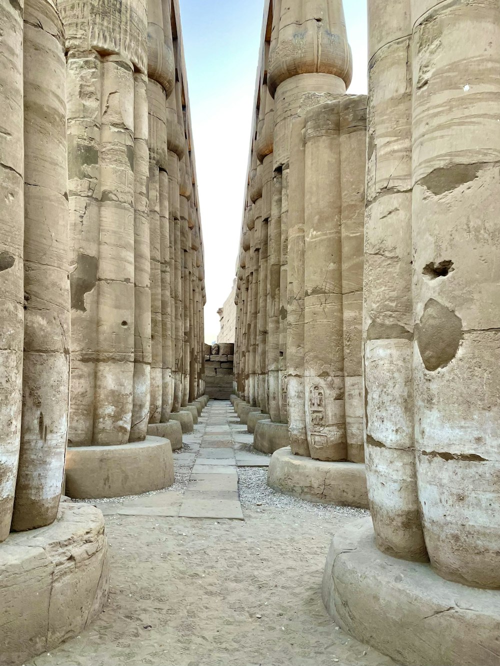 a narrow walkway between two large stone pillars