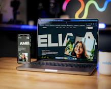a laptop computer sitting on top of a wooden table
