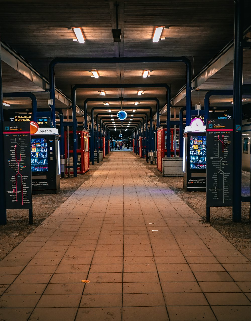 a train station with a long line of train carts