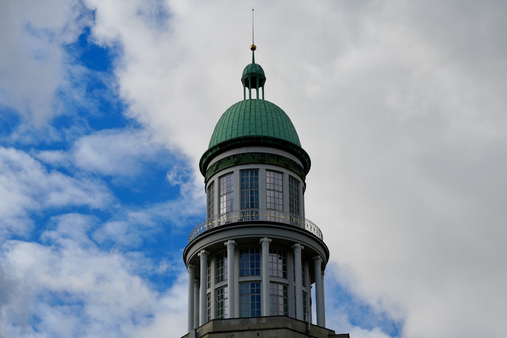 a tall building with a green dome on top